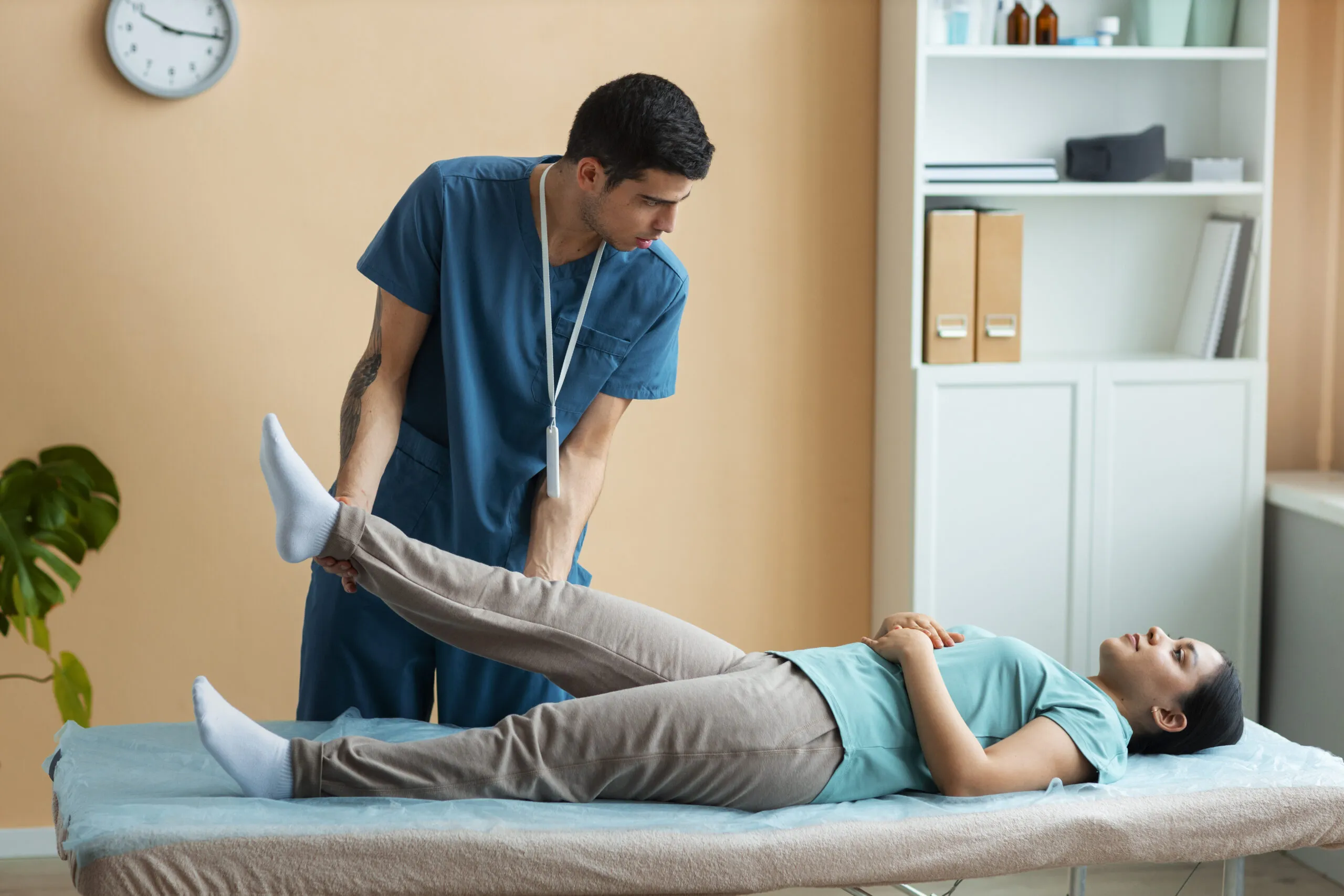 doctor helping patient in rehabilitation